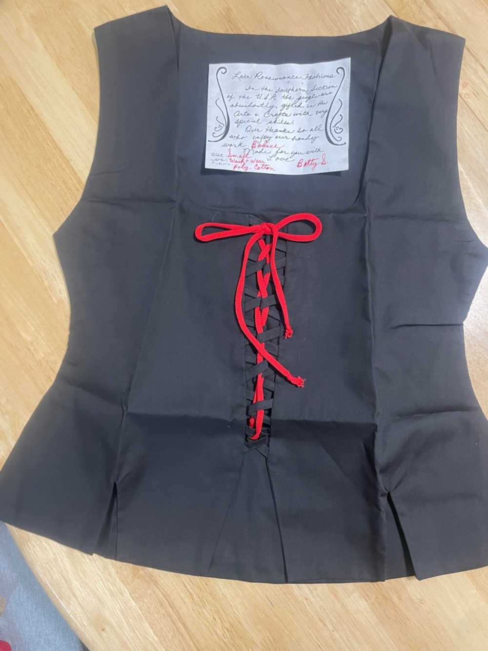 Black Sleeveless Lace-Up Peplum Top with Red Trim